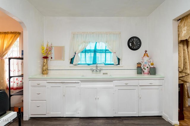 3247 La Clede Ave, Los Angeles, CA 90039 - kitchen featuring a sink, arched walkways, light countertops, white cabinets, and dark wood-type flooring