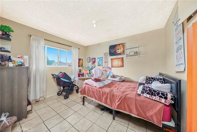333 W D St, Wilmington, CA 90744 - bedroom with a textured ceiling, tile patterned floors, and baseboards