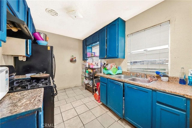 333 W D St, Wilmington, CA 90744 - kitchen featuring black appliances, a sink, blue cabinetry, and light tile patterned floors