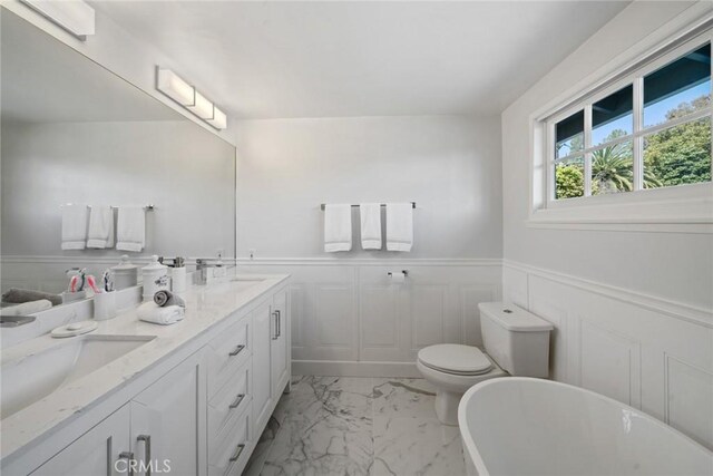 4420 Conchita Way, Tarzana, CA 91356 - full bathroom featuring marble finish floors, a soaking tub, wainscoting, double vanity, and a decorative wall