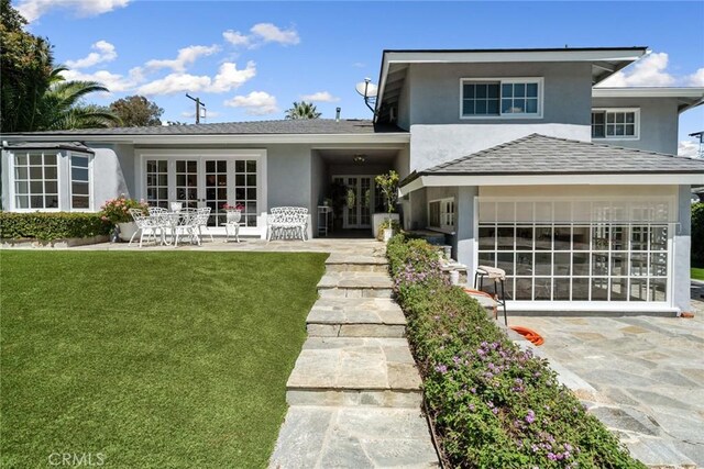 4420 Conchita Way, Tarzana, CA 91356 - view of front of home with stucco siding, french doors, a front yard, and a patio