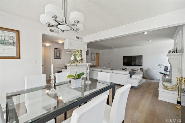 4420 Conchita Way, Tarzana, CA 91356 - dining area with a chandelier, hardwood / wood-style flooring, a textured ceiling, and ornamental molding