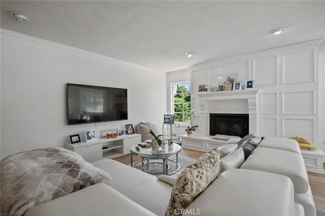 4420 Conchita Way, Tarzana, CA 91356 - living area with wood finished floors, crown molding, a textured ceiling, and a glass covered fireplace