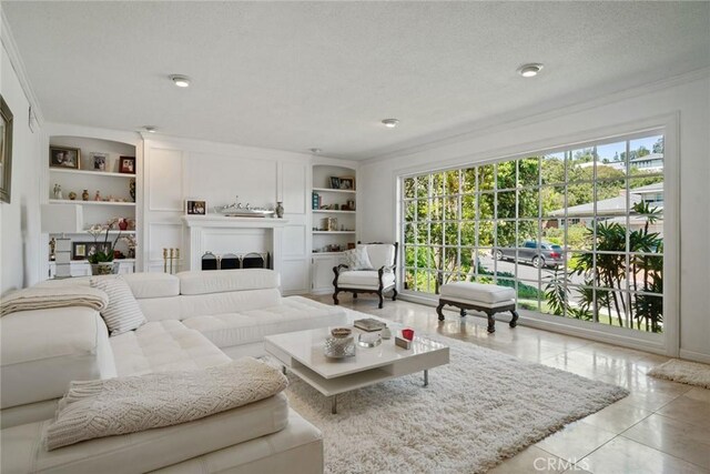 4420 Conchita Way, Tarzana, CA 91356 - tiled living area featuring crown molding, plenty of natural light, built in shelves, and a textured ceiling