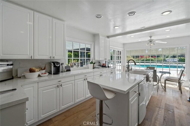 4420 Conchita Way, Tarzana, CA 91356 - kitchen with a sink, wood finished floors, white cabinetry, a ceiling fan, and recessed lighting