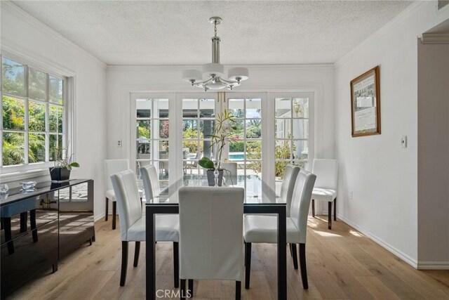 4420 Conchita Way, Tarzana, CA 91356 - dining room featuring a chandelier, crown molding, light wood-style flooring, a textured ceiling, and baseboards