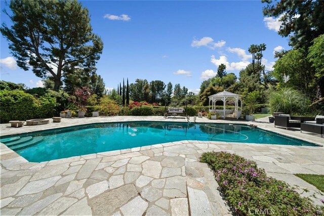 4420 Conchita Way, Tarzana, CA 91356 - outdoor pool with a gazebo, a patio area, an outdoor hangout area, and view of wooded area