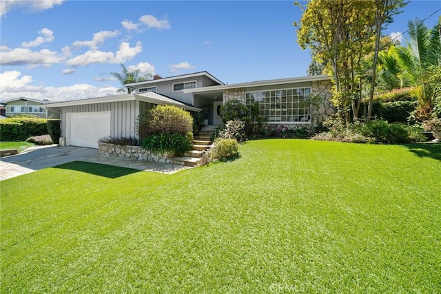 4420 Conchita Way, Tarzana, CA 91356 - split level home with a front lawn, driveway, an attached garage, and stone siding