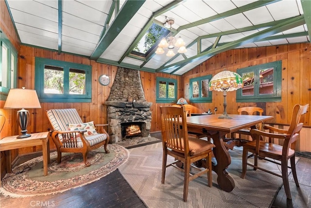 25 Hot Spring Canyon Rd, San Juan Capistrano, CA 92675 - dining space with wood walls, vaulted ceiling, a fireplace, a chandelier, and wood finished floors