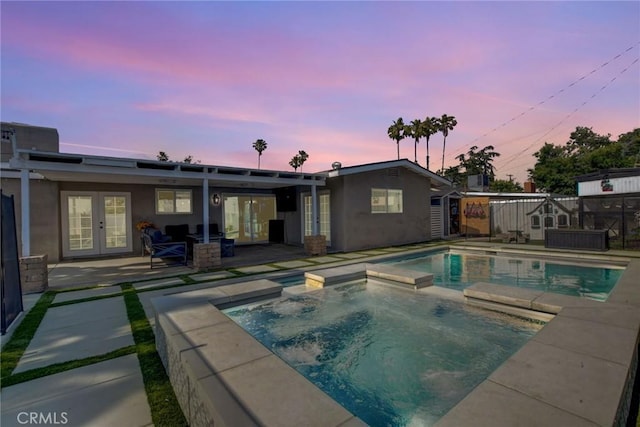 9463 Alder St, Rancho Cucamonga, CA 91730 - pool at dusk with french doors, a pool with connected hot tub, and a patio area