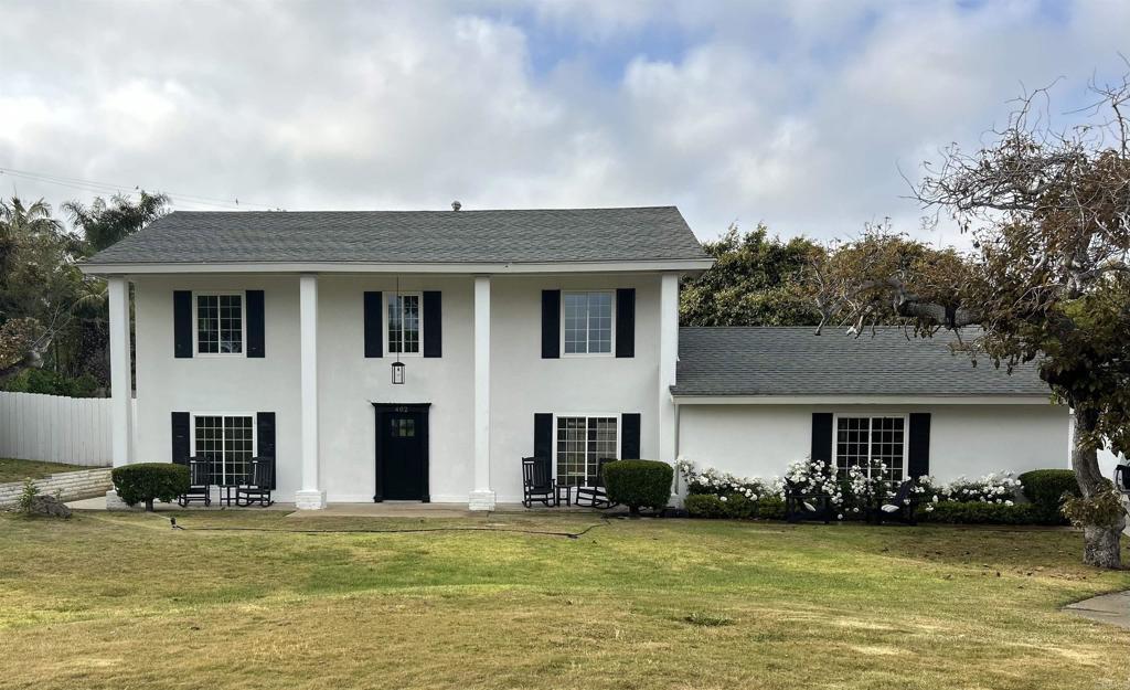 402 Parkwood Ln, Encinitas, CA 92024 - greek revival house with stucco siding and a front yard