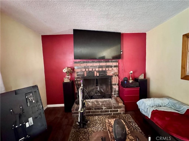 9547 Marion Ave, Montclair, CA 91763 - living area with wood finished floors, a textured ceiling, and a stone fireplace