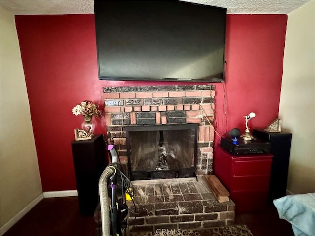 9547 Marion Ave, Montclair, CA 91763 - detailed view of baseboards, a fireplace with raised hearth, and wood finished floors