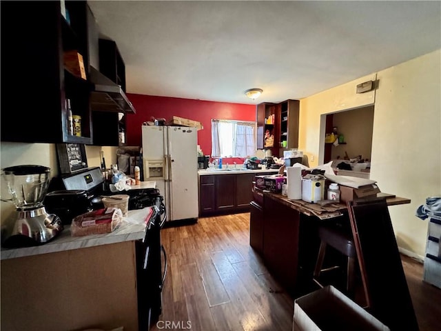 9547 Marion Ave, Montclair, CA 91763 - kitchen featuring white fridge with ice dispenser, light countertops, light wood-type flooring, and open shelves
