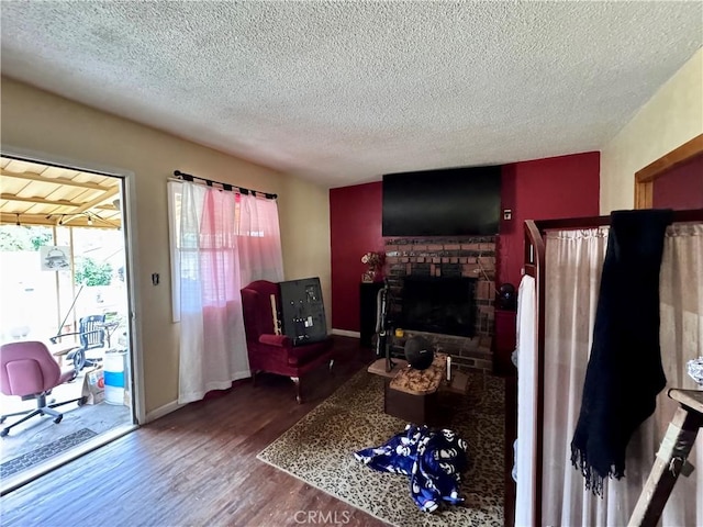 9547 Marion Ave, Montclair, CA 91763 - living room with a textured ceiling, wood finished floors, a fireplace, and baseboards