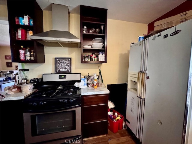 9547 Marion Ave, Montclair, CA 91763 - kitchen featuring stainless steel range with gas stovetop, wall chimney exhaust hood, white fridge with ice dispenser, open shelves, and dark wood finished floors