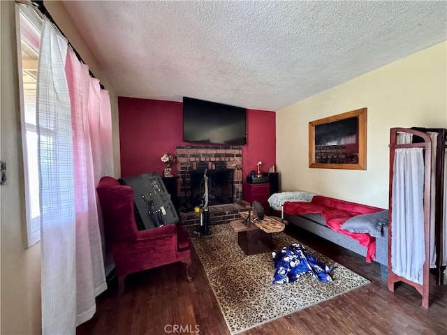 9547 Marion Ave, Montclair, CA 91763 - living area with wood finished floors, a textured ceiling, and a fireplace