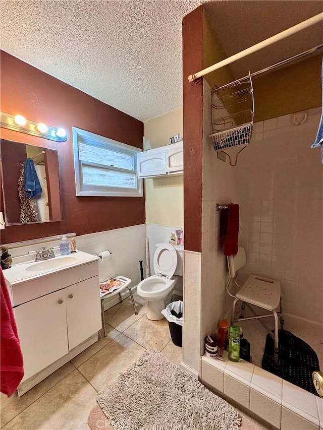 9547 Marion Ave, Montclair, CA 91763 - full bathroom with vanity, tiled shower, a textured ceiling, tile patterned floors, and toilet