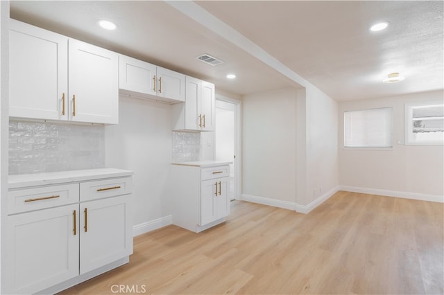 8235 Coleman St, Riverside, CA 92504 - kitchen featuring light countertops, decorative backsplash, light wood-style flooring, baseboards, and recessed lighting