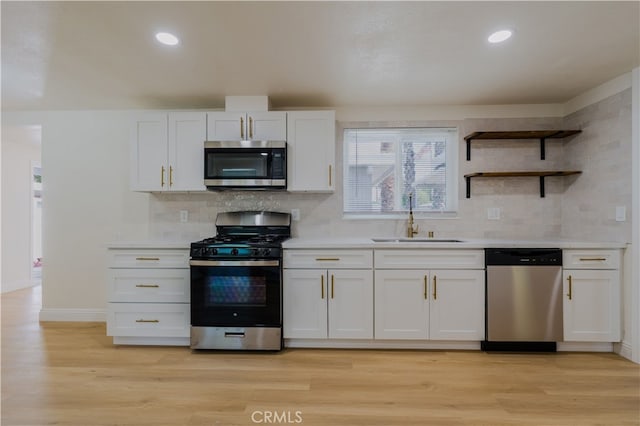 8235 Coleman St, Riverside, CA 92504 - kitchen with appliances with stainless steel finishes, a sink, white cabinetry, tasteful backsplash, and recessed lighting