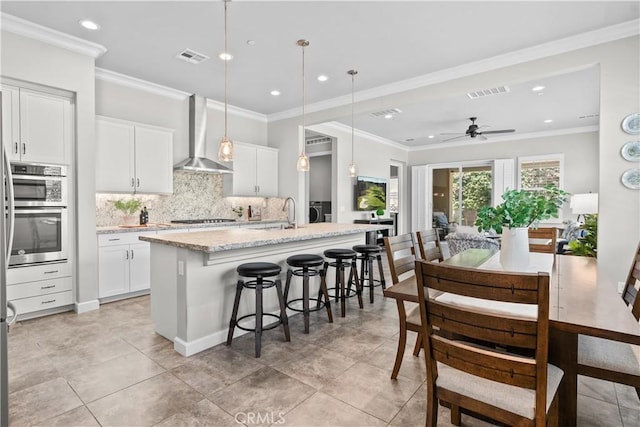 147 Luneta Ln, Rancho Mission Viejo, CA 92694 - kitchen with wall chimney range hood, ceiling fan, a sink, tasteful backsplash, and recessed lighting