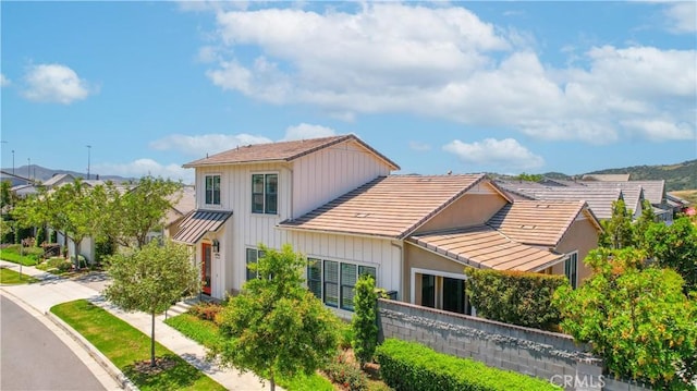 147 Luneta Ln, Rancho Mission Viejo, CA 92694 - view of front of house with a tile roof, board and batten siding, and a standing seam roof