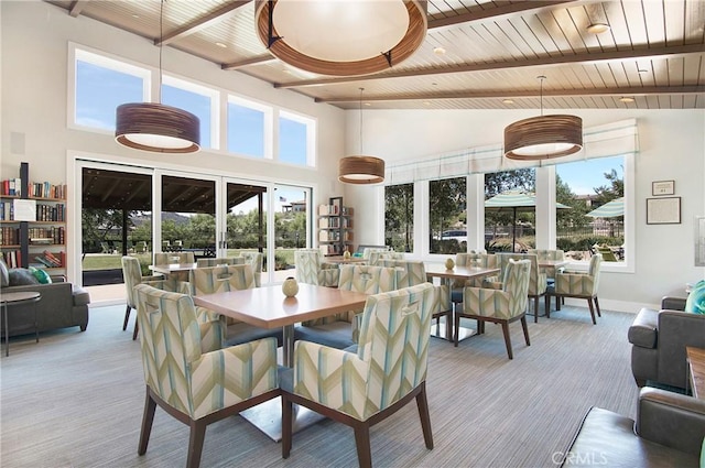147 Luneta Ln, Rancho Mission Viejo, CA 92694 - dining room with a towering ceiling, wooden ceiling with exposed beams, plenty of natural light, carpet, and baseboards