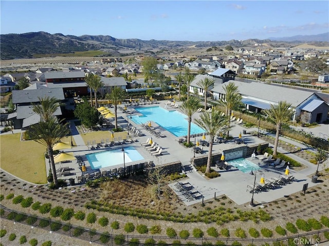 147 Luneta Ln, Rancho Mission Viejo, CA 92694 - aerial perspective of suburban area featuring a pool area and a mountain backdrop