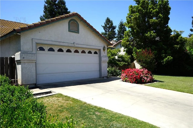 2068 Spy Glass Ct, Merced, CA 95340 - view of front facade featuring stucco siding, driveway, a tile roof, and an outdoor structure
