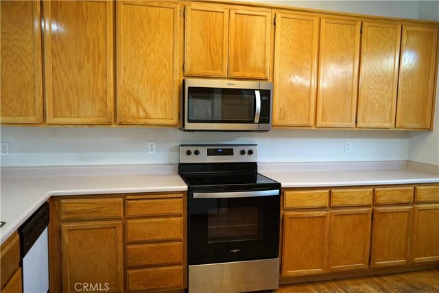 2068 Spy Glass Ct, Merced, CA 95340 - kitchen featuring stainless steel appliances, light countertops, and brown cabinetry