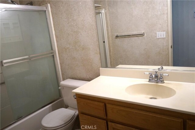 2068 Spy Glass Ct, Merced, CA 95340 - full bathroom featuring toilet, vanity, and bath / shower combo with glass door