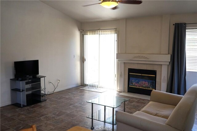 2068 Spy Glass Ct, Merced, CA 95340 - living area with a ceiling fan, baseboards, plenty of natural light, and dark stone finish flooring