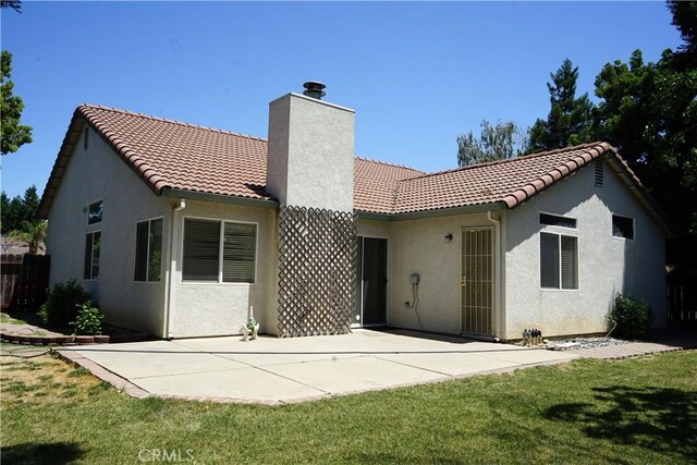 2068 Spy Glass Ct, Merced, CA 95340 - rear view of property with a tiled roof, a chimney, a patio area, and stucco siding