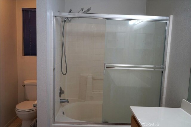 2068 Spy Glass Ct, Merced, CA 95340 - bathroom with toilet, vanity, and combined bath / shower with glass door