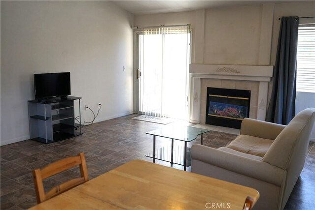 2068 Spy Glass Ct, Merced, CA 95340 - living area featuring baseboards, stone finish floors, plenty of natural light, and a tile fireplace