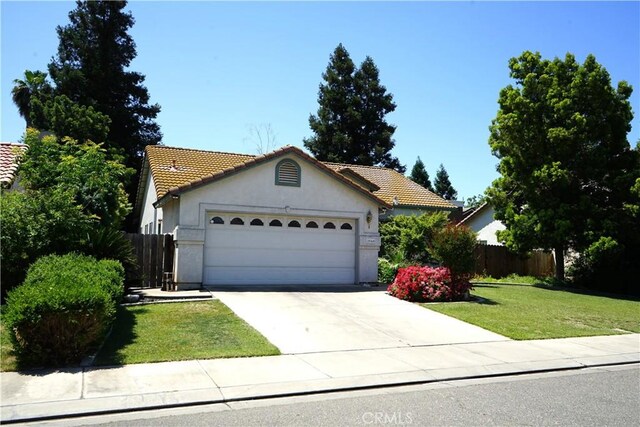 2068 Spy Glass Ct, Merced, CA 95340 - ranch-style home with a tile roof, an attached garage, concrete driveway, and stucco siding