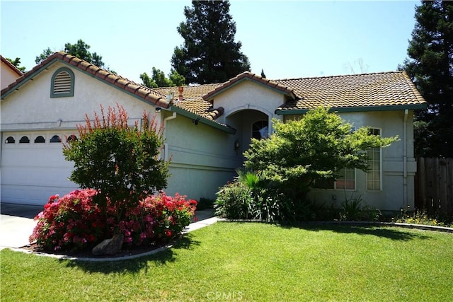 2068 Spy Glass Ct, Merced, CA 95340 - mediterranean / spanish house with an attached garage, a tiled roof, and stucco siding