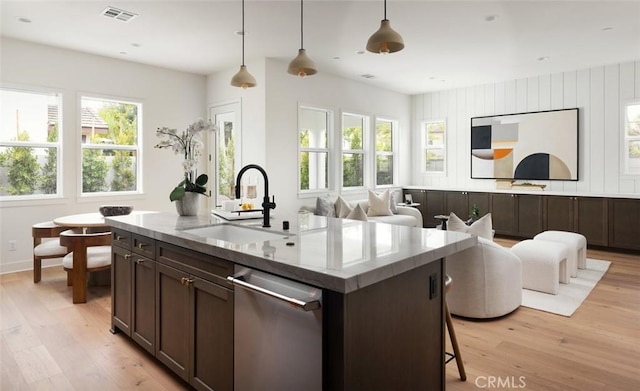 18017 Roch Ct, Fountain Valley, CA 92708 - kitchen with a sink, stainless steel dishwasher, light wood-style floors, dark brown cabinets, and a kitchen island with sink