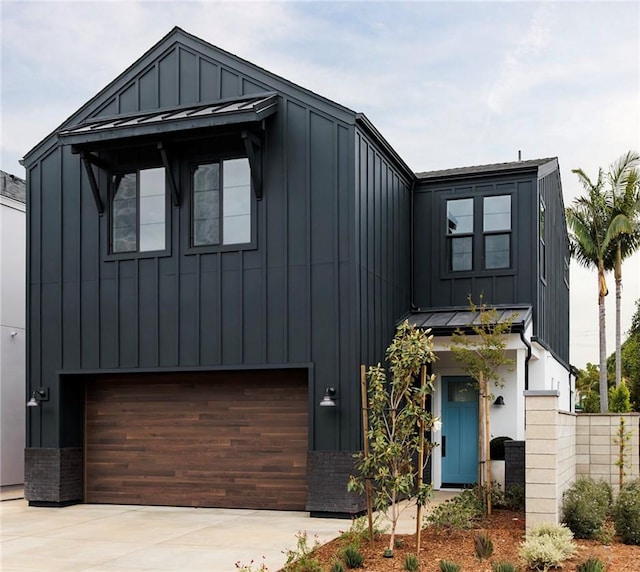 18017 Roch Ct, Fountain Valley, CA 92708 - view of front facade with board and batten siding, an attached garage, driveway, and a standing seam roof