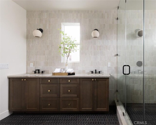 18017 Roch Ct, Fountain Valley, CA 92708 - bathroom featuring double vanity, a shower stall, tile patterned flooring, and tile walls