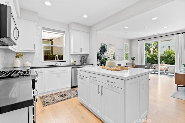 28 Fosco St, Rancho Mission Viejo, CA 92694 - kitchen with a sink, appliances with stainless steel finishes, light wood-style floors, backsplash, and recessed lighting