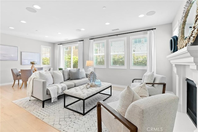 28 Fosco St, Rancho Mission Viejo, CA 92694 - living area featuring recessed lighting, light wood-type flooring, a fireplace, and baseboards