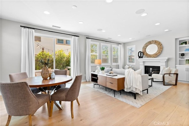 28 Fosco St, Rancho Mission Viejo, CA 92694 - dining space featuring a glass covered fireplace, recessed lighting, and light wood-style flooring