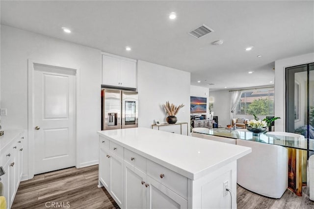 747 Spring Gdn, Irvine, CA 92618 - kitchen with stainless steel refrigerator with ice dispenser, a kitchen island, wood finished floors, white cabinetry, and recessed lighting