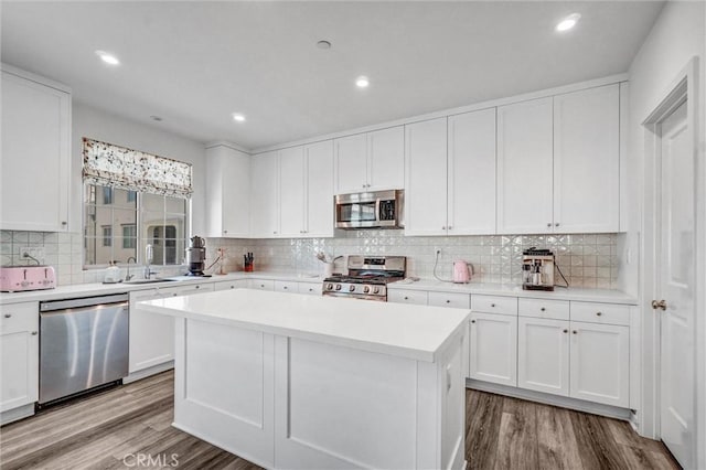 747 Spring Gdn, Irvine, CA 92618 - kitchen featuring stainless steel appliances, wood finished floors, a center island, light countertops, and white cabinetry