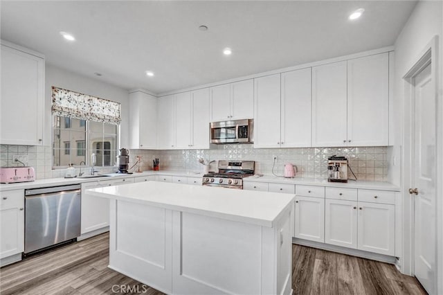 747 Spring Gdn, Irvine, CA 92618 - kitchen with stainless steel appliances, wood finished floors, a center island, light countertops, and white cabinetry