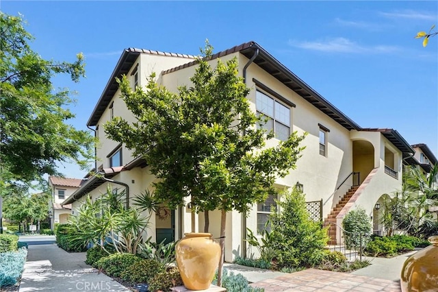 747 Spring Gdn, Irvine, CA 92618 - view of side of property with stucco siding and stairway