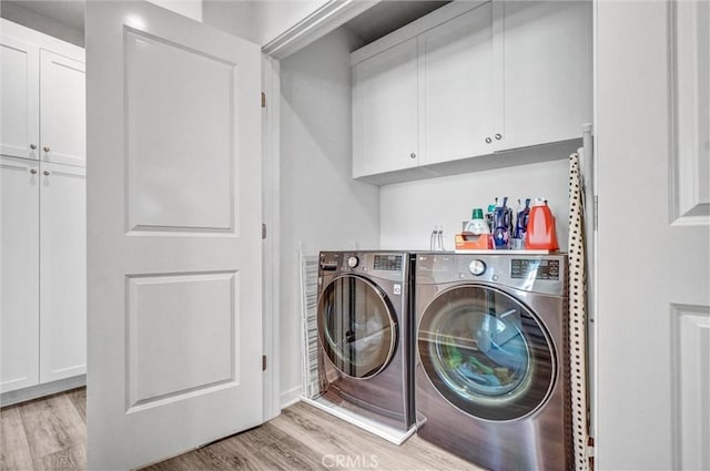 747 Spring Gdn, Irvine, CA 92618 - laundry room featuring cabinet space, washing machine and clothes dryer, and light wood-style floors