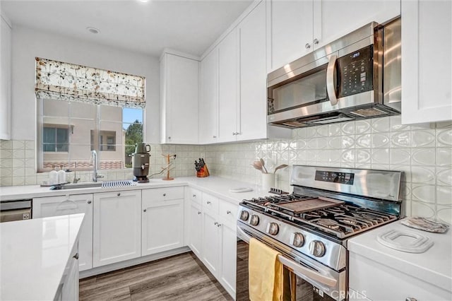 747 Spring Gdn, Irvine, CA 92618 - kitchen featuring appliances with stainless steel finishes, light countertops, white cabinets, and light wood-type flooring