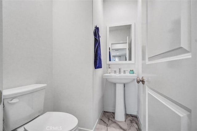 747 Spring Gdn, Irvine, CA 92618 - half bathroom with marble look tiles, toilet, baseboards, and a sink